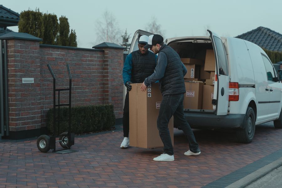 Movers loading boxes into a van